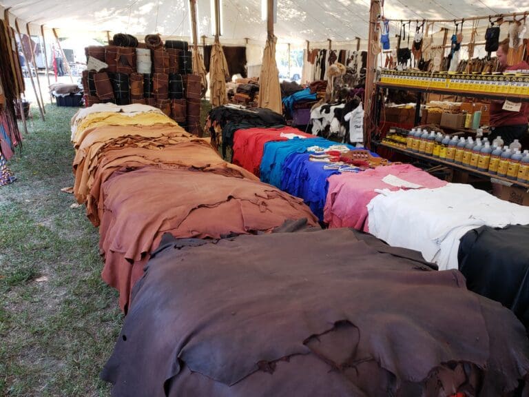 Leather hides displayed in a market tent.