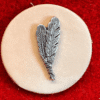 Three feathers emblem on red background.