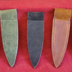 20230417_152733 Five leather knife sheaths on red fabric.