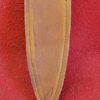 Brown leather knife sheath on red background.