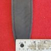 Knife sheath and ruler on red fabric.