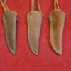 Three brown leather knife sheaths on display.
