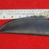 Black knife sheath next to measuring ruler.
