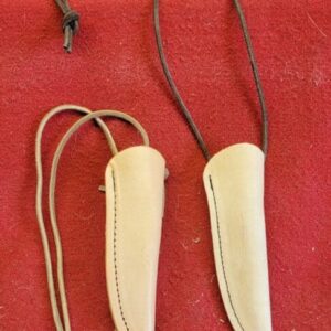 20230420_164740 Leather sheaths with cords on red background.