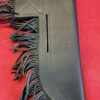 Black leather fringe sheath on red background.