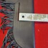 Leather pouch with fringe and ruler.