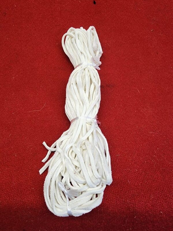 20240106_135529 White shoelaces bundle on red surface.