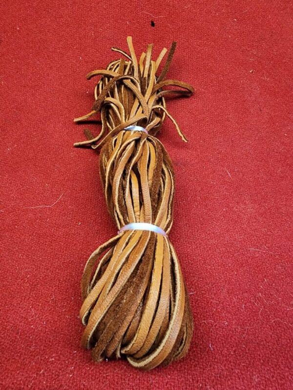 20240106_135555 Bundle of brown leather laces on carpet.