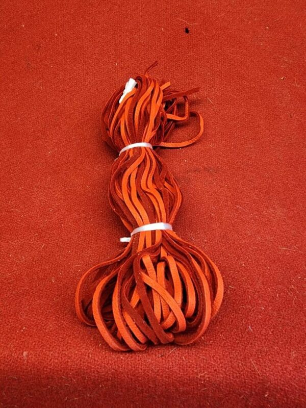 20240106_135656 Red shoelaces coiled on red background.