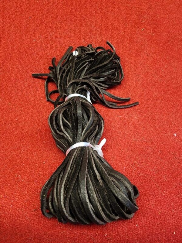 20240106_135846 Bundle of black cables on red surface.