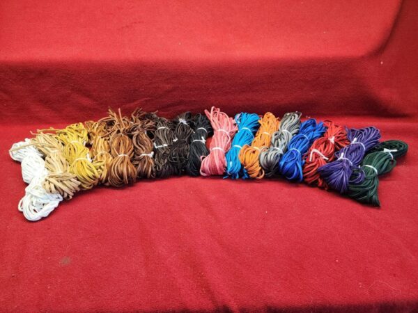 20240106_141316 Colorful shoelaces arranged on red fabric.