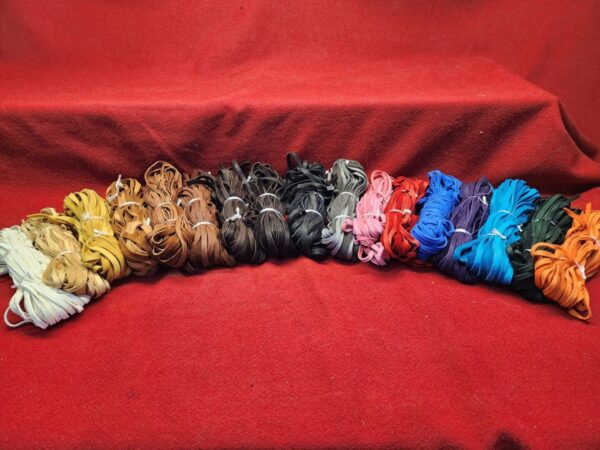 Colorful bundles of fabric on red background.