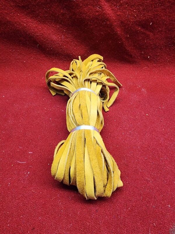 Bundle of yellow suede leather strips.