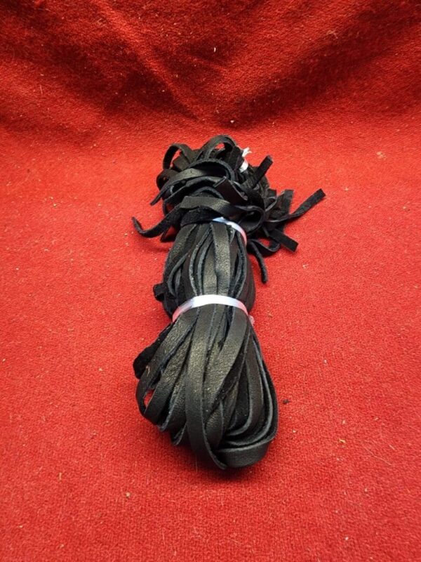 Black leather strips on red background.