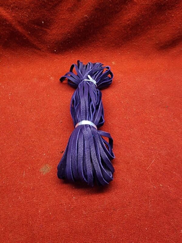 Purple leather strips on red fabric.