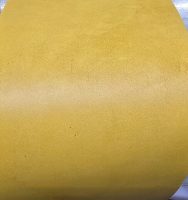 20241227_122330 Yellow textured surface of a rolled material.