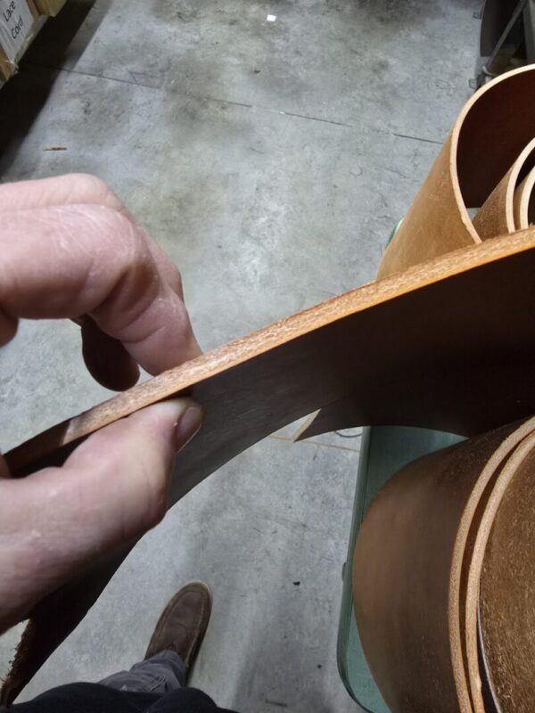 20241227_124512 Hand holding a piece of leather.