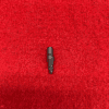 Small black object on red textured background.