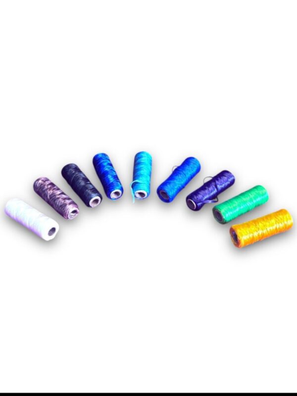 Colorful spools of thread arranged in arc.