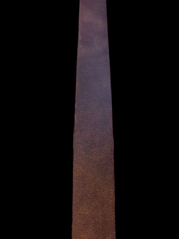 Brown leather strip on black background.