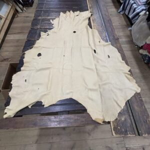 IMG_2884 Tan leather hide on wooden table.