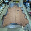 Large brown leather hide on wood table.