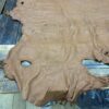 Brown leather hide on a wooden surface.