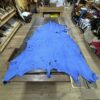 Blue leather hide on wooden table.