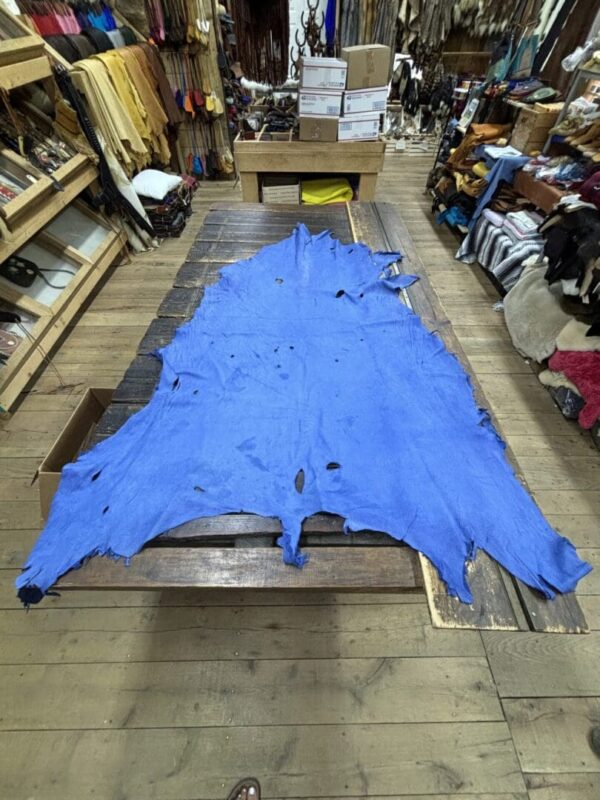 Blue leather hide on wooden table.