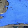 Blue leather hide on wooden table.