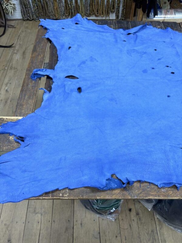 Blue leather hide on wooden table.