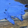 Blue leather scrap on wood table.