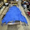 Blue leather hide on wooden table.
