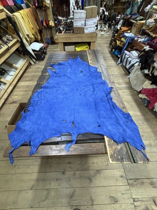 Blue leather hide on wooden table.