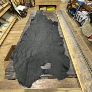 IMG_2904 Black leather hide on wooden table.