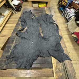 IMG_2909 - Copy Two pieces of black leather on wood.