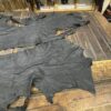 IMG_2911 Black leather hides on wooden table.