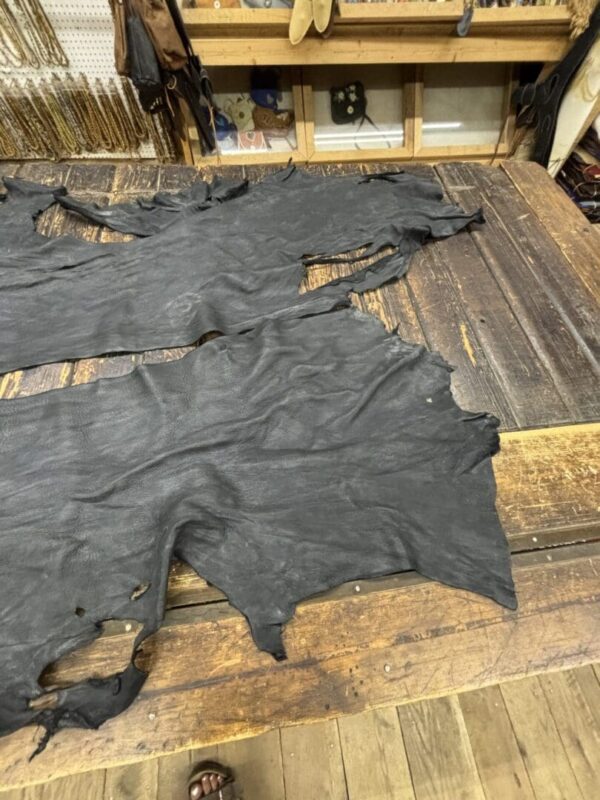 IMG_2911 Black leather hides on wooden table.