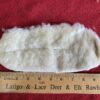 White fur piece next to a ruler.