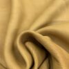 Soft beige leather fabric with folds.