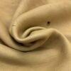 Beige fabric with a curled fold.