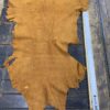 Brown leather hide on wooden table.