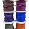 Colorful spools of ribbon stacked together.