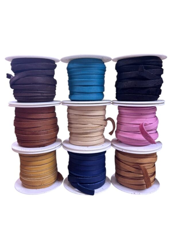 Assorted colorful rolls of ribbon spools.