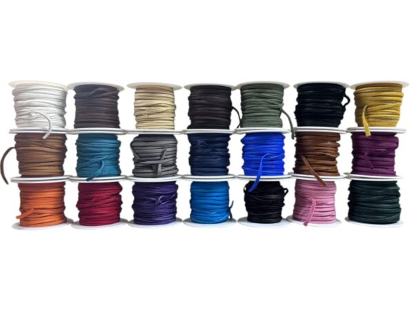 Colorful spools of various laces arranged neatly.