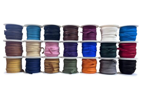 Colorful spools of ribbon arranged in rows.