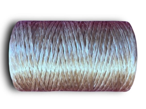 Gradient-colored spool of yarn, close-up.