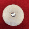 Beige buffing wheel with metal screw.