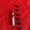 Tool set with bits on red surface.
