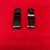 Two metal clips on red background.